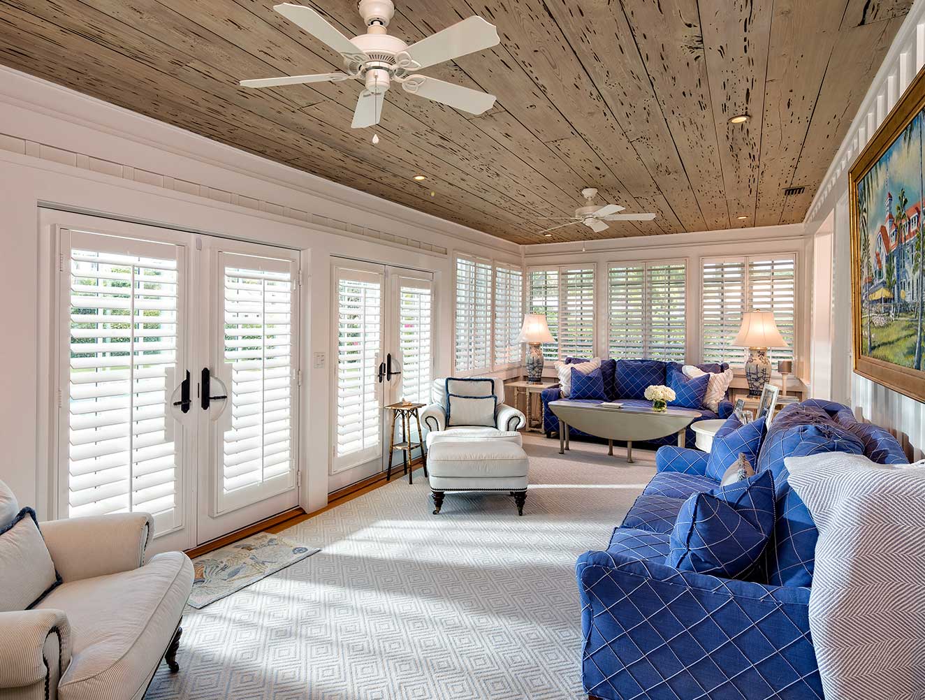 Coastal Florida sun room with crown molding and decorative wood panel ceiling