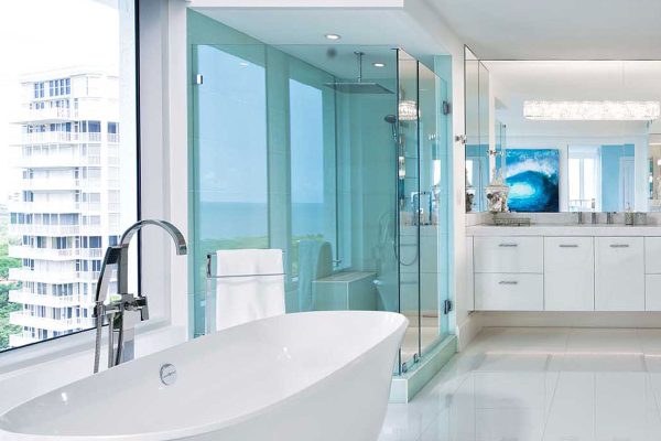 Luxury high-rise condominium bathroom remodel with free standing bath rub, custom vanity and large walk-in shower
