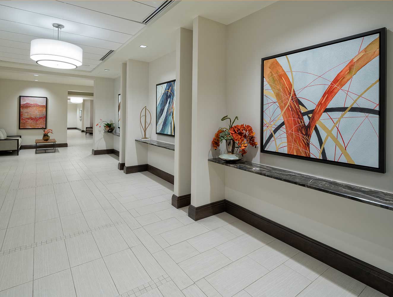 Modern commercial walk way with abstract art decor and custom granite wall ledges